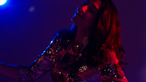Close-Up-Of-Woman-In-Nightclub-Bar-Or-Disco-Dancing-With-Sparkling-Lights-5